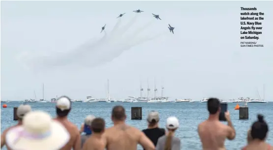  ?? PAT NABONG/ SUN-TIMES PHOTOS ?? Thousands watch along the lakefront as the U.S. Navy Blue Angels fly over Lake Michigan on Saturday.