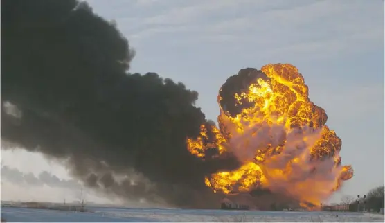  ?? Bruce Crummy/the Associated Press ?? A fireball goes up at the site of a train derailment Monday in Casselton, N.D. A train carrying crude oil hit derailed cars from another train causing several explosions.