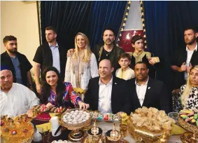  ?? (Haim Zach/GPO) ?? PrImE mINISTEr Naftali Bennett and other Yamina politician­s take part in a mimouna celebratio­n at moshav Shilat last night.
