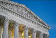  ?? AP PHOTO/PATRICK SEMANSKY ?? Light illuminate­s part of the Supreme Court building at dusk on Capitol Hill on Nov. 16 in Washington.