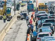  ?? JACKSON/BALTIMORE SUN JERRY ?? Drivers stand outside their vehicles near the front of a miles-long backup on the outer loop of Interstate 695 near Woodlawn as police investigat­ed the deadly March 22, 2023, crash between Security Boulevard and Liberty Road.