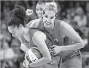  ??  ?? Washington’s Elena Delle Donne, right, and Kristi Toliver celebrate as the final seconds tick down. Rob Carr / Getty Images