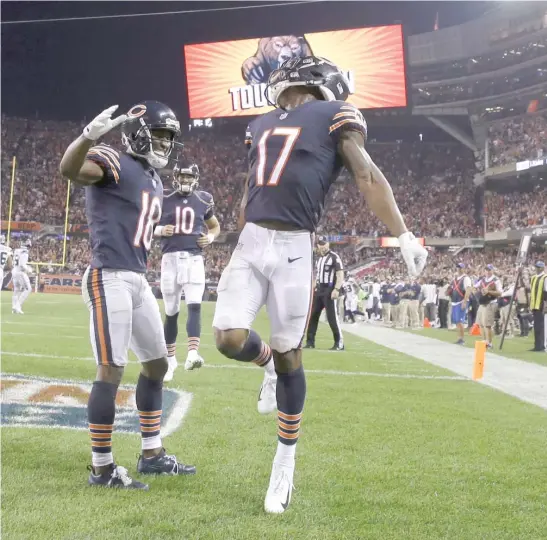  ?? AP ?? The Bears’ Anthony Miller (17) celebrates with fellow receiver Taylor Gabriel after catching a touchdown pass in the fourth quarter against the Seahawks at Soldier Field.