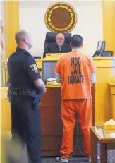  ?? ADOLPHE PIERRE-LOUIS/JOURNAL ?? Tony Torrez, right, addresses District Judge Charles Brown after being sentenced to 16 years in the October 2015 fatal shooting of Lilly Garcia. The image was shot through a courtroom window.