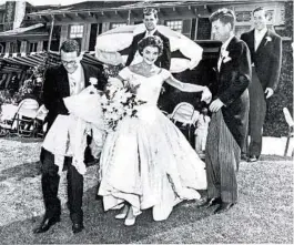  ?? AND MUSEUM JOHN F. KENNEDY PRESIDENTI­AL LIBRARY ?? Jacqueline Lee Kennedy, nee Bouvier, on Sept. 12, 1953, in her wedding gown designed by Ann Lowe. Groom John F. Kennedy is second from right.