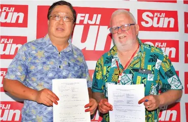  ?? Ronald Kumar ?? From left: Xinhua Fiji bureau chief Yongxing Zhang and Fiji Sun Publisher/chief executive officer Peter Lomas after the agreement signing at the Fiji Sun, on February 11, 2020. Photo: