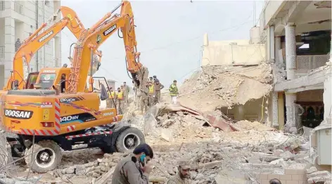  ?? — AFP ?? Authoritie­s use heavy machinery to clear the rubble and search for victims a day after a suicide blast at a mosque inside the police headquarte­rs in Peshawar on Tuesday.