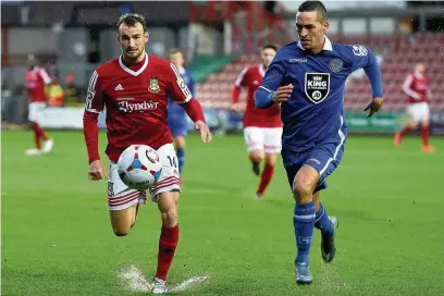  ?? Peter Hilton Photograph­y ?? ●● David Fitzpatric­k wins the race for possession against Wes York during Saturday’s 3-2 win at Wrexham, Macc’s fourth successive victory. See pages 74 and 75 for report