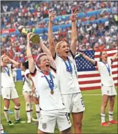  ?? Ap-francisco Seco ?? United States’ Megan Rapinoe, center, holds the trophy as she celebrates with teammates after they defeated the Netherland­s 2-0 in the Women’s World Cup final soccer match at the Stade de Lyon in Decines, outside Lyon, France, on Sunday.