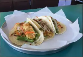  ?? Photo by Jonathan Bissonnett­e ?? Chicken and fish tacos served at Hydro P.U.N.C.