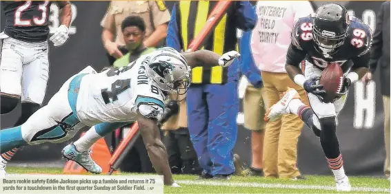  ?? | AP ?? Bears rookie safety Eddie Jackson picks up a fumble and returns it 75 yards for a touchdown in the first quarter Sunday at Soldier Field.