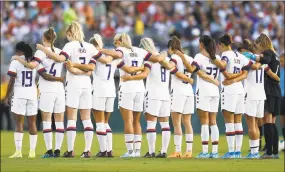  ?? Katharine Lotze / Getty Images ?? The starting lineup of the United States Women's National Team observes a moment of silence for the victims of the El Paso shooting.