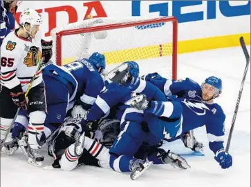  ?? Mike Carlson Getty Images ?? TAMPA BAY’S Ryan Callahan, right, is part of a big pileup in front of the Chicago net in the third period.