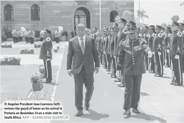  ??  ?? Angolan President Joao Lourenco (left) reviews the guard of honor on his arrival in Pretoria on November 24 on a state visit to South Africa. AFP / GIANLUIGI GUERCIA