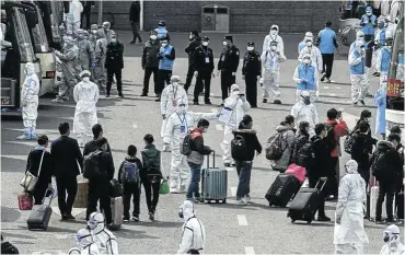  ?? Picture: Kevin Frayer/Getty Images ?? The scene in April last year in Beijing when travellers arriving from Wuhan, epicentre of the Covid outbreak, were sent to quarantine facilities. It has yet to be conclusive­ly determined how the virus began spreading in humans, and the US is seeking to establish whether it could have escaped from a Wuhan laboratory.