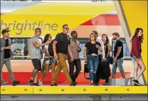  ?? GREG LOVETT / THE PALM BEACH POST ?? Brightline passengers arrive Friday in West Palm Beach from Fort Lauderdale. Many of the passengers were headed to SunFest, which kicked off Thursday.