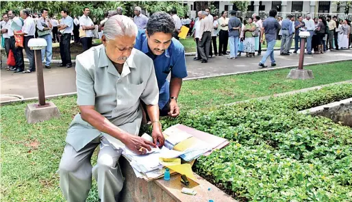  ??  ?? File picture of an aggrieved depositor of the failed Golden Key company goes through his papers outside the Supreme Court during the numerous cases against the company. It was the middle class that had placed deposits in this company to get a higher return.