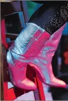  ?? SEAN D. ELLIOT/THE DAY ?? Dottie Yaworski owns 60 pairs of cowboy boots, including these silver ones.