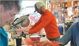  ?? Courtesy photo ?? Volunteers and members of the Yuba Watershed Protection and Fire Safe Council work to turn recycled fire hose into tow chain covers meant to mitigate the chance of a spark that could lead to a wildfire.