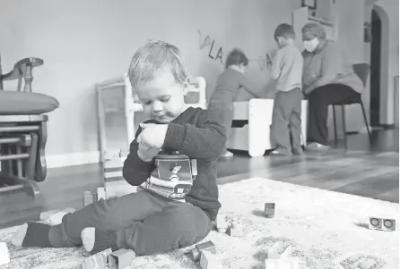  ?? PHOTOS BY DAN POWERS/ USA TODAY NETWORK ?? Henry McSorley, 2, plays with toys as Burke Miller, 2, and Ethan Miller, 3, participat­e in a math activity with Nicole Leitermann at Impression­s Family Child Care In Kimberly, Wis.