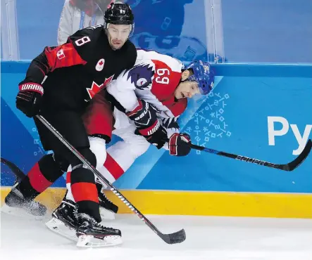  ?? JULIO CORTEZ/THE ASSOCIATED PRESS ?? Wojtek Wolski (8) of Canada checks Lukas Radil (69) of the Czech Republic during the first period of a preliminar­y-round men’s hockey game in Gangneung, South Korea, on Saturday. Canada was looking to improve to 2-0 in the tournament.