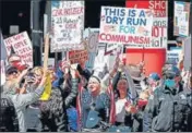  ?? AFP ?? Angry protesters hold banners during a demonstrat­ion demanding the reopening of the US economy, in Chicago, Illinois.