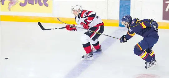  ?? PHOTOS: ASHLEY FRASER ?? The Ottawa 67’s Sasha Chmelevski tries to pull away from defender Kirill Nizhnikov of the Barrie Colts in Sunday’s home opener at TD Place. The Colts won 7-5.