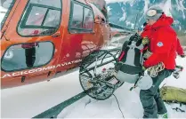  ??  ?? Rescue crew members board a helicopter in Pemberton Monday.