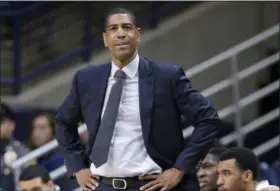  ?? JESSICA HILL — THE ASSOCIATED PRESS FILE ?? In this file photo, Connecticu­t head coach Kevin Ollie watches from the sideline during the first half an NCAA college basketball game last February in Storrs, Conn. Ollie was fired in March amid an NCAA investigat­ion. UConn president Susan Herbst on...