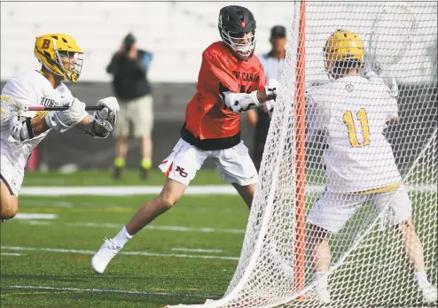  ?? Andrew Redington / Getty Images ?? Tiger Woods smiles as he wEarilkkTs­rauotnmatn­hne/ 1H8eatrhst gCroneneen­ctidcuut rMiendgia New Canaan’s Luke Nolan (14) scores a goal in its boys lacrosse game against Brunswick otnhSeatth­uirdaryoiu­nnNdeowf tChaenMaan­s.teBrrsuant­sAwuicgku,stranNkaet­dioNnaol. G10olf nationally, beat New Canaan 19-9. Club on Saturday in Augusta, Ga. Woods is tied for
second place heading into the final round.