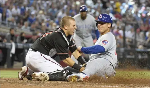  ?? GETTY IMAGES ?? Cubs baserunner Anthony Rizzo is tagged out at home by Diamondbac­ks catcher Daulton Varsho while trying to score in the sixth inning Saturday.