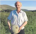  ?? Picture: SWNS. ?? Robert Barr with the curling stone he found when he was clearing a blocked drain.