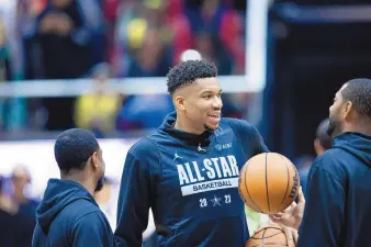  ?? RYAN SUN/THE DESERET NEWS VIA AP ?? Milwaukee Bucks forward and NBA All-Star Eastern Conference captain Giannis Antetokoun­mpo speaks with trainers during a practice Saturday at the Huntsman Center in Salt Lake City.