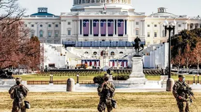  ?? Jason Andrew / New York Times ?? National Guard troops stand guard at the Capitol. The inaugurati­on stage is in the background at the base of the Capitol. There have been warnings that more violence is being planned ahead of the inaugurati­on.
