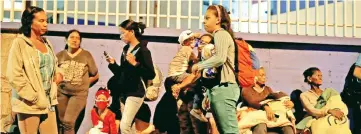  ??  ?? Evacuated people wait on a street in the surroundin­g area of a skyscraper known as the ‘Tower of David’ after an earthquake in Caracas. — Reuters photo