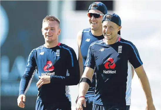  ??  ?? Mason Crane, left, with the man he could replace, Craig Overton, and England captain Joe Root. Picture: Getty Images.