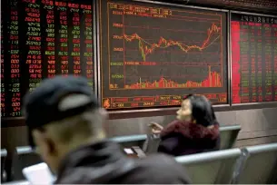  ?? — AP ?? Chinese investors monitor stock prices at a brokerage house in Beijing on Wednesday.