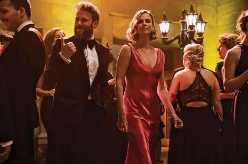  ?? Murray Close / Lionsgate via Washington Post ?? Seth Rogen and Charlize Theron play an unlikely romantic couple in “Long Shot.” Rogen’s memoir covers adolescenc­e and moments in Hollywood.