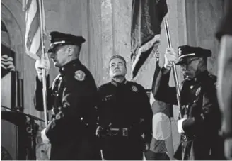  ?? Photos by AAron Ontiveroz, The Denver Post ?? Paul Pazen stands for the color guard during his swearing-in ceremony as the new chief of the Denver Police Department on Monday.