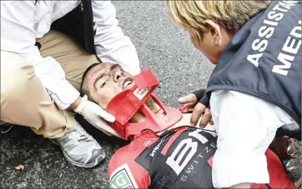  ?? PHILIPPE LOPEZ/AFP ?? Australia’s Richie Porte receives medical assistance after falling during the 181.5km ninth stage of the 104th edition of the Tour de France between Nantua and Chambery on Sunday.