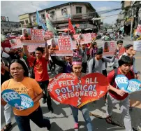  ?? AP ?? Protesters hold a rally in Quezon city, north of Manila, demanding the release of Filipino activist Ferdinand Castillo and to urge President Duterte to resume talks with communist rebels. —