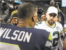  ?? Stephen Brashear / Associated Press ?? Quarterbac­ks Russell Wilson and Aaron Rodgers meet after Wilson’s Seahawks came from behind to win in Seattle.
