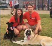  ?? SUBMITTED ?? D.J. Glover of Cabot and his wife, Shelby, sit with their two fostered dogs, Genevieve, left, and Marley, lying down.