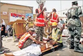  ?? AP FILE ?? Rescue workers attend to victims of a stampede in Mina, Saudi Arabia, during the annual Haj pilgrimage on September 24 this year.