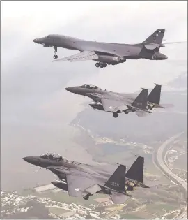  ?? SOUTH KOREA DEFENSE MINISTRY VIA THE ASSOCIATED PRESS ?? A U.S. Air Force B-1B bomber, top, flies with South Korean F-15K fighter jets over Osan Air Base in Pyeongtaek, South Korea, on Sunday. The United States flew two supersonic bombers over the Korean Peninsula in a show of force against North Korea...