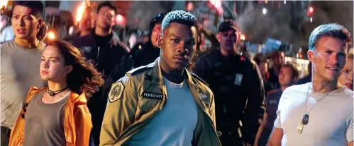  ?? Universal Pictures ?? ■ Shown, foreground from left, are Cailee Spaeny, John Boyega and Scott Eastwood in a scene from "Pacific Rim Uprising."