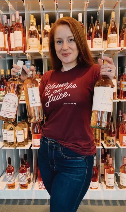  ?? PHOTO OuRTESy lyDiA gill ?? THINK PINK: Lydia Gill, wine tasting coordinato­r at Urban Grape, shows off her favorite summertime rosés.