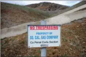  ??  ?? A sign declares the boundary line of the Southern California Gas Co. gas fields where a well has been leaking methane daily near the Porter Ranch community. A state of emergency has been declared.