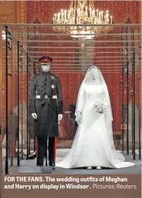  ?? Pictures: Reuters ?? FOR THE FANS. The wedding outfits of Meghan and Harry on display in Windsor .