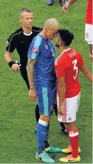  ??  ?? Wales defender Neil Taylor goes nose to chin with Slovakia’s Miartin Skrtel